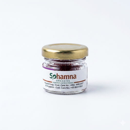 Saffron spice jar with gold lid and Sohamna Organics label, glass of red threads