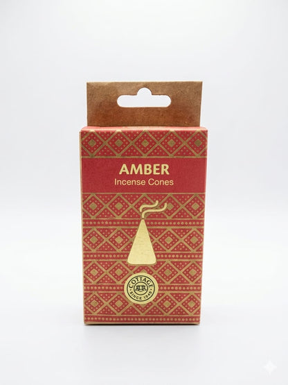 A package of Amber Incense Cones by Sohamna Organics, featuring a red and gold patterned box with a kraft paper hanger tab on a white background.