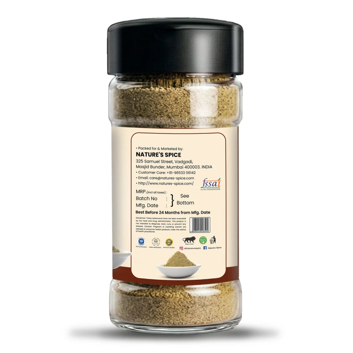 A clear plastic spice jar with a black lid and a beige back label, showing ground spices inside. The label includes the brand name 'Sohamna Organics' and a website URL, set against a plain white background.