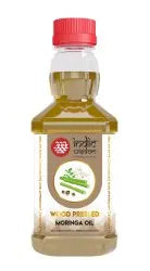 A bottle of Moringa Oil with a red cap and a clear label, containing a yellowish-green oil, shown against a plain white background.