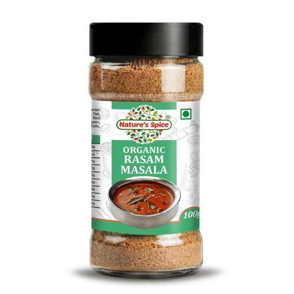 A 100g plastic spice jar of Nature's Spice Organic Rasam Masala, featuring a black lid and a white and green label with an image of a prepared dish, set against a plain white background.