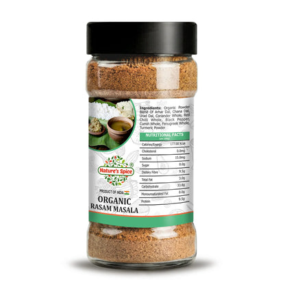 A clear plastic spice jar filled with organic Rasam Masala powder, featuring a black lid and a white label with green and red accents. The label displays the brand 'Nature's Spice' and the product name 'Organic Rasamasa'.